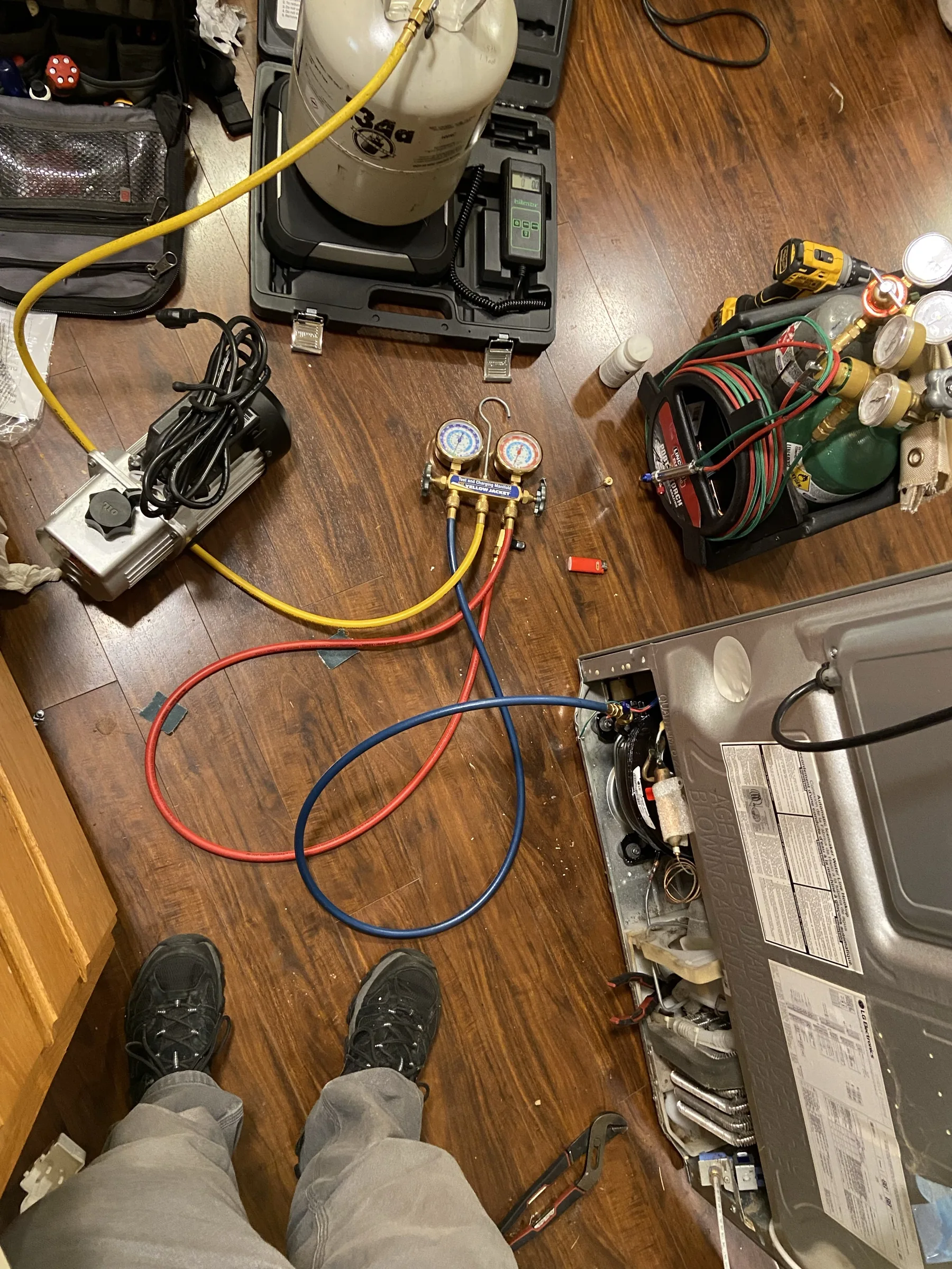 Refrigeration gauges and tools during an appliance repair